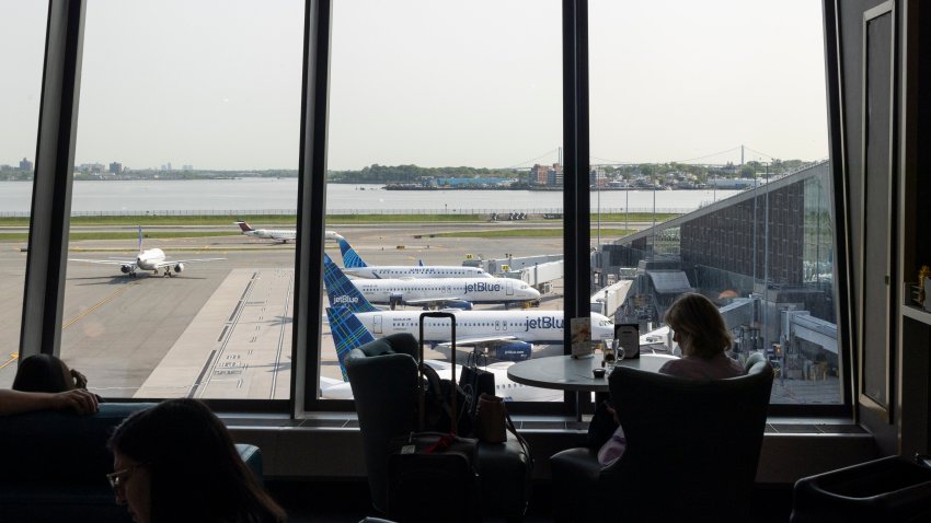 Silhouette of passenger sitting in the airport terminal of LaGuardia Airport in New York City