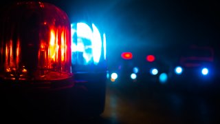 Police car blue and red round vintage siren in dark. Rotating retro style police siren. Selective focus