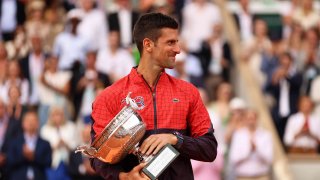 Novak Djokovic of Serbia celebrates with the winners trophy after victory against Casper Ruud of Norway in the Men’s Singles Final match on Day Fifteen of the 2023 French Open at Roland Garros on June 11, 2023 in Paris, France.