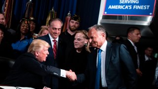 US President Donald Trump shakes Ike Perlmutter, CEO of Marvel Entertainment, hand before signing an executive order at the US Department of Veterans Affairs April 27, 2017 in Washington, DC.