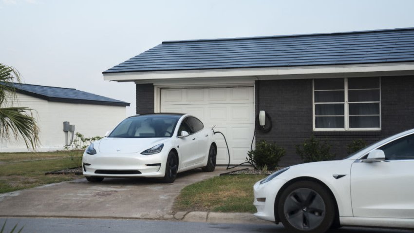 Tesla vehicles parked outside a home with a Tesla Solar Roof on Weems Street in Boca Chica Village, Texas, June 21, 2021.