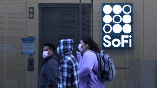 Pedestrians walk by the SoFi Technologies headquarters on February 22, 2022 in San Francisco, California.