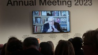 Former U.S. diplomat Henry Kissinger appears on a screen as he delivers a video address to the participants of the World Economic Forum (WEF) 2023, in the Alpine resort of Davos, Switzerland, January 17, 2023.