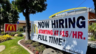 A Now hiring sign at McDonald”u2019s restaurant in Yorba Linda, CA, on Monday, Sept. 13, 2021 offering pay from $15 an hour for new employees as signs around the region are getting the cold shoulder from workers reluctant to resume service-industry jobs.”