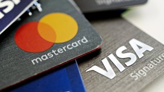 Visa Inc. and Mastercard Inc. credit cards are arranged for a photograph in Tiskilwa, Illinois, U.S.