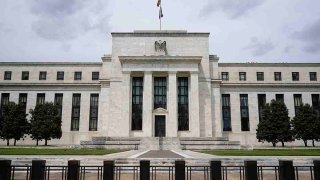 FILE - An American flag flies over the Federal Reserve building on May 4, 2021, in Washington.