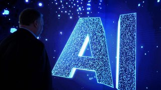 A visitor watches an AI (Artificial Intelligence) sign on an animated screen at the Mobile World Congress (MWC), the telecom industry’s biggest annual gathering, in Barcelona.