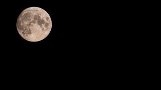 Beautiful full Moon of August, August’s Sturgeon Supermoon in a summer night. Moon above, on the left side and empty space on the right side for writing