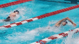 Transgender swimmer Lia Thomas (R) of Penn University and transgender swimmer Iszac Henig (L) of Yale compete in the 100-yard freestyle swimming race at the 2022 Ivy League Women’s Swimming & Diving Championships at Harvard University