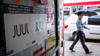 Juul Labs signage is seen in the window of a store in San Francisco, June 25, 2019.