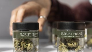 A worker sets up Florist Farms cannabis products on the first day of legal recreational marijuana sales at the Housing Works Cannabis Co. in New York, on Thursday, Dec. 29, 2022.