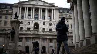 People walk outside the Bank of England in the City of London financial district, in London, Britain, January 26, 2023.