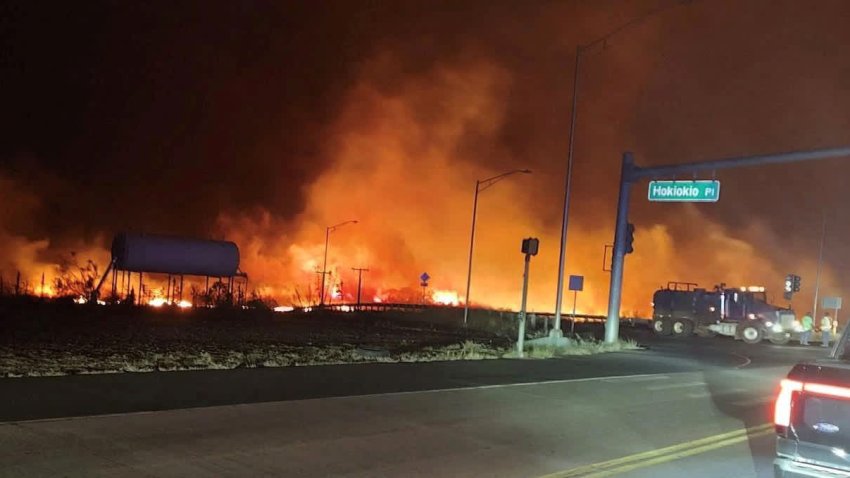 A wildfire burns on the island of Maui near an intersection in Lahaina, Hawaii, August 9, 2023.