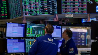 Traders work on the floor of the New York Stock Exchange during the opening bell, Aug. 21, 2023.