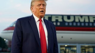 Former President Donald Trump speaks with reporters before departure from Hartsfield-Jackson Atlanta International Airport, Thursday, Aug. 24, 2023, in Atlanta.