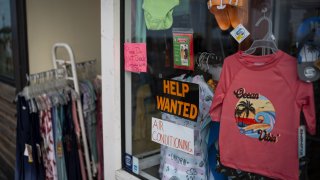 A help wanted sign on a storefront in Ocean City, New Jersey, US, on Friday, Aug. 18, 2023. Surveys suggest that despite cooling inflation and jobs gains, Americans remain deeply skeptical of the president’s handling of the post-pandemic economy. Photographer: Al Drago/Bloomberg via Getty Images