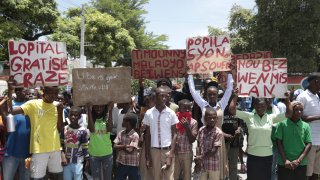 Students from the El Roi academy carry signs during a demonstration to demand the freedom of New Hampshire nurse Alix Dorsainvil and her daughter, who have been reported kidnapped, in the Cite Soleil neighborhood of Port-au-Prince, Haiti, Monday, July 31, 2023.