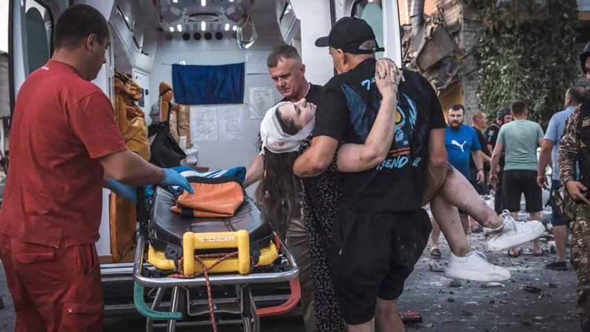 In this photo provided by the Ukrainian Emergency Service, people carry a wounded person from a damaged building after Russian missile strikes in Pokrovsk, Donetsk region, Ukraine, Monday, Aug. 7, 2023.