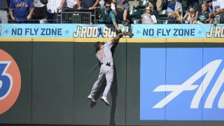 Baltimore Orioles center fielder Cedric Mullins catches a ball hit by Seattle Mariners' Ty France over the fence