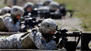 FILE – Female soldiers from 1st Brigade Combat Team, 101st Airborne Division train on a firing range while testing new body armor in Fort Campbell, Ky., Sept. 18, 2012.