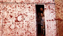 People are photographed inside a house during the annual tomato fight fiesta called "Tomatina" in the village of Bunol near Valencia, Spain, Wednesday, Aug. 30, 2023. 