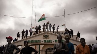 Protesters hold a Niger flag during a demonstration on independence day in Niamey on August 3, 2023.