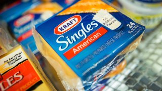 Packages of Kraft Foods’ Singles cheese slices are displayed at a supermarket in New York.