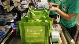 InstaCart employees fulfill orders for delivery