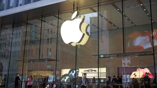 Shoppers in masks outside front of Apple flagship store