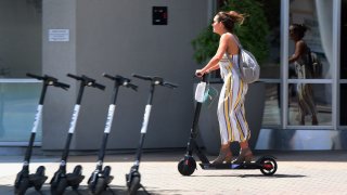 Woman rides a Bird e-scooter in southern California.