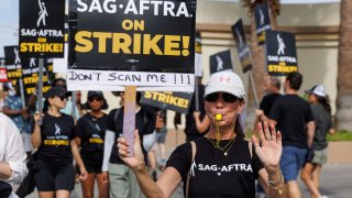 Actor Karen Brown walks the picket line with fellow SAG-AFTRA actors and Writers Guild of America writers in front of Paramount Studios in Los Angeles, July 17, 2023.