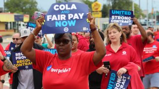 Members of the United Auto Workers union hold a rally and practice picket near a Stellantis plant in Detroit, Aug. 23, 2023.