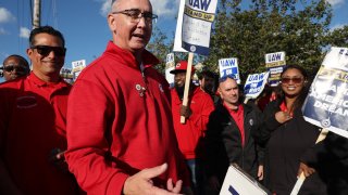 United Auto Workers President Shawn Fain, middle, visits striking UAW Local 551 workers outside a Ford assembly center on South Burley Avenue on Saturday, Oct. 7, 2023, in Chicago.