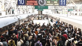 Passengers return from Nanjing Railway Station in Nanjing, Jiangsu province, China, Oct 6, 2023.