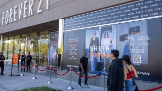Shoppers walks past advertisements on the opening day of fast fashion e-commerce giant Shein, which is hosting a brick-and-mortar pop up inside Forever 21 at the Ontario Mills Mall in Ontario Thursday, Oct. 19, 2023.
