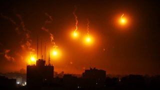 A lighting flare, fired by Israel illuminates the sky in Al-Sudaniya, region in the northwest of Gaza on October 30, 2023.