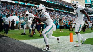 Tyreek Hill of the Miami Dolphins celebrates a touchdown during the first half in the game against the Carolina Panthers at Hard Rock Stadium on Oct. 15, 2023 in Miami Gardens, Fla.