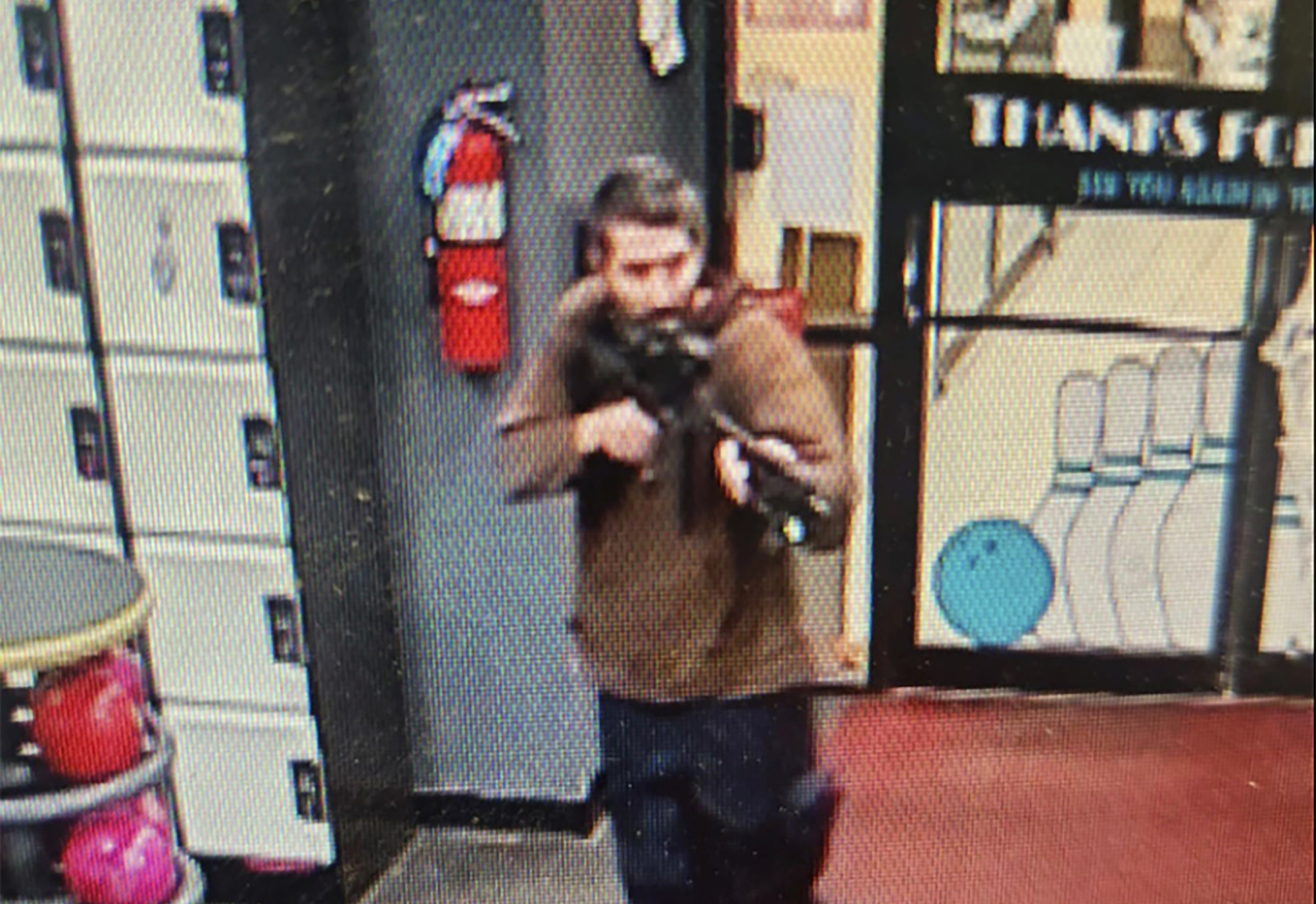 In this image taken from video released by the Androscoggin County Sheriff’s Office, an unidentified gunman points a gun while entering Sparetime Recreation in Lewiston, Maine, on Wednesday, Oct. 25, 2023.