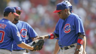 Manager Dusty Baker of the Chicago Cubs hands the ball to relief pitcher Will Ohman during a game against the St. Louis Cardinals at Busch Stadium in St. Louis, Mo. on July 23, 2005.  The Cubs won 6-5. (Photo by G. N. Lowrance/Getty Images)