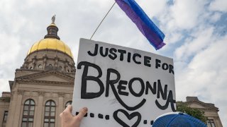 FILE - Demonstrators march through downtown in honor of Breonna Taylor