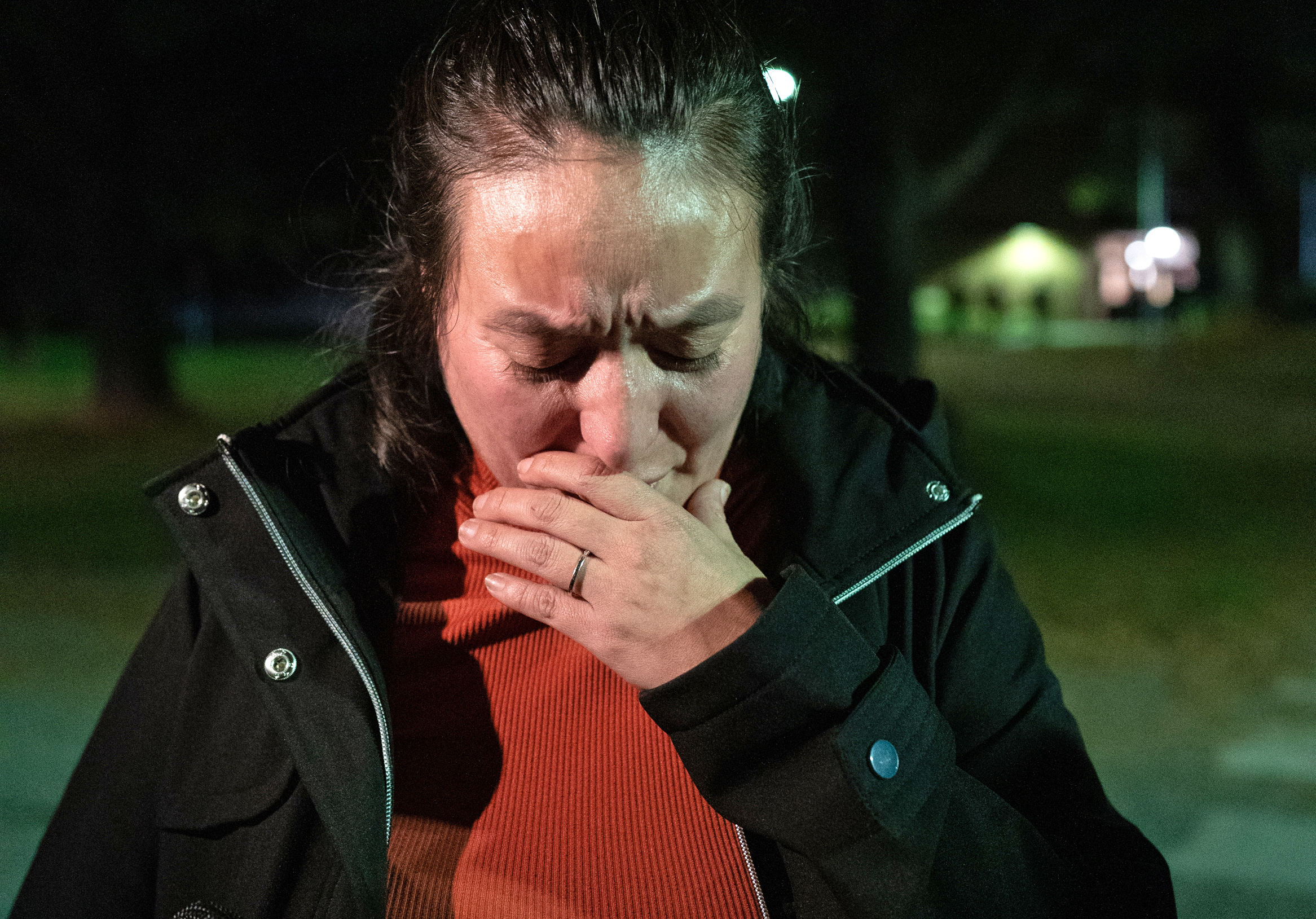 Maria Wilson shows emotion near a reunification center set up at Auburn Middle School on early Thursday, Oct. 26, 2023 in Auburn, Maine. Wilson came to the reunification center trying to find out information about a person she knew who was at Schemengees Bar and Grille at the time of the shooting.