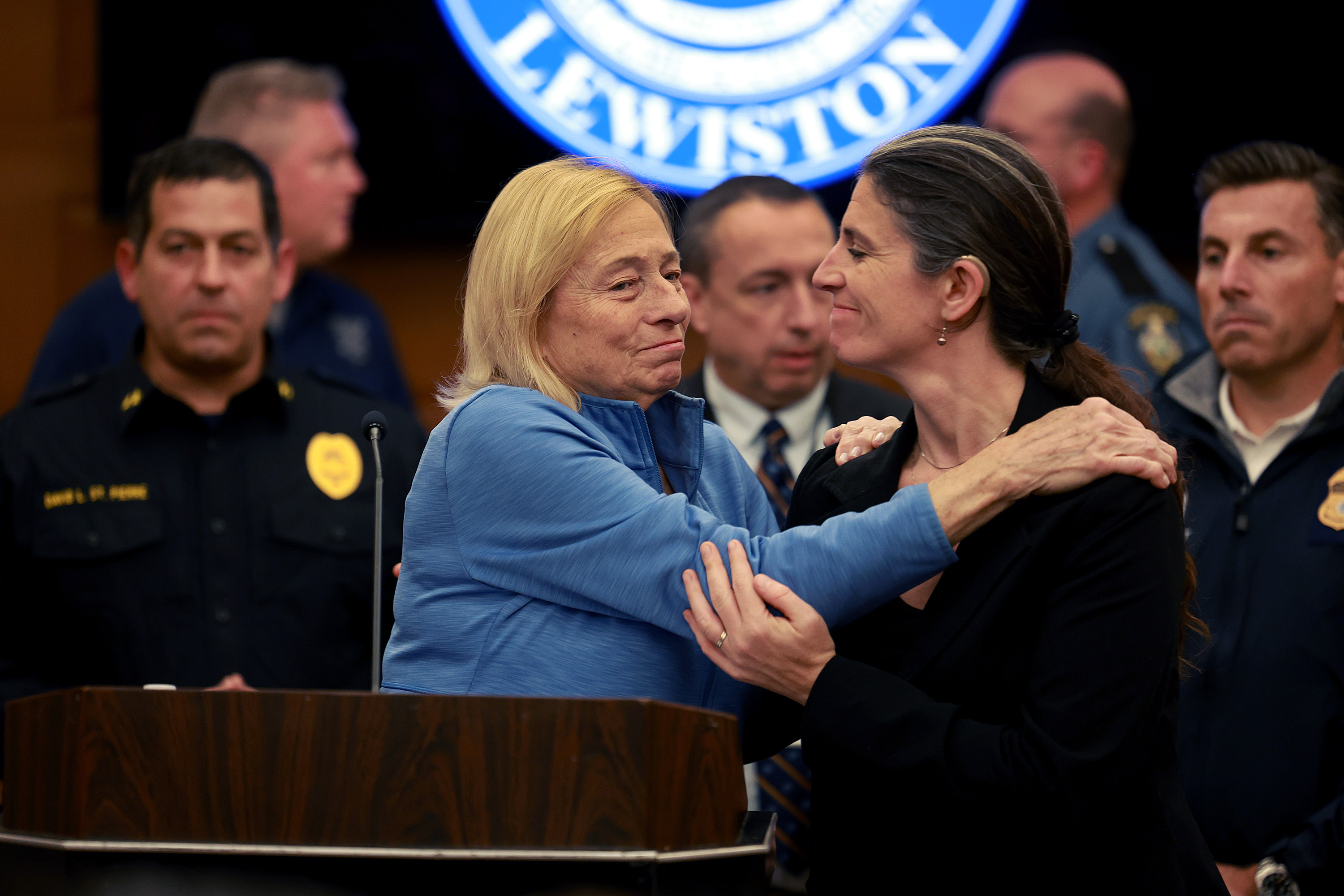 LEWISTON, MAINE – OCTOBER 27: Governor Janet Mills of Maine is embraced before she announces to the media that Robert Card, the suspect in two mass killings, was found dead on October 27, 2023 in Lewiston, Maine. Mr. Card, who allegedly killed 18 people in a mass shooting at a bowling alley and restaurant in Lewiston was found dead in nearby Lisbon. (Photo by Joe Raedle/Getty Images)