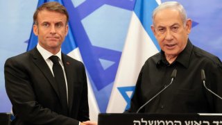 Israeli Prime Minister Benjamin Netanyahu (R) shakes hands with French President Emmanuel Macron (L) after their joint press conference in Jerusalem on October 24, 2023.