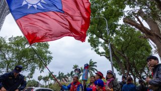 A KMT supporter waves a giant Taiwan’s national flag outside of Central Election Commission on November 24, 2023 in Taipei, Taiwan. 