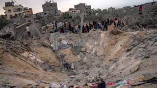 Palestinians look for survivors following an Israeli airstrike