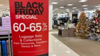 A sign announces Black Friday specials on luggage sets inside a Macy’s department store on Monday, Nov. 20, 2023, in Denver. Retailers are kicking off the unofficial start of the holiday shopping season on Friday with a bevy of discounts and other enticements.