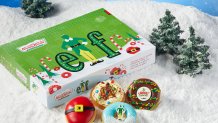 A box of Elf-themed Krispy Kreme donuts on a bed of snow.