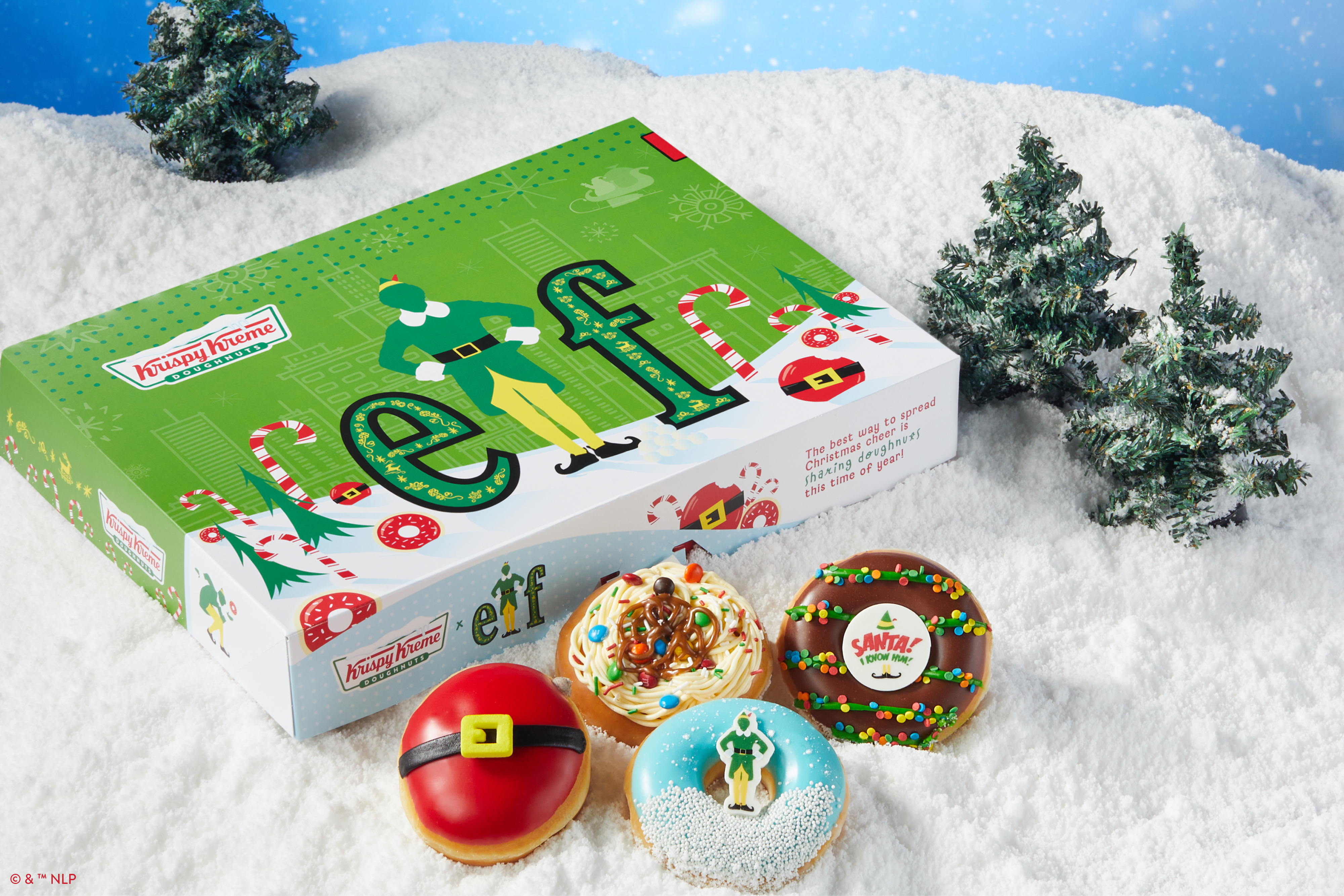 A box of Elf-themed Krispy Kreme donuts on a bed of snow.