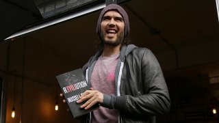 FILE - Russell Brand speaks at the opening of The Trew Era Cafe, a social enterprise community project on the New Era estate in east London, March 26, 2015.