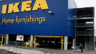 A customer pushes purchased items outside of an Ikea store in Brooklyn, New York.